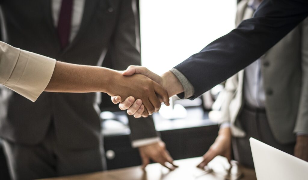 Business professionals shaking hands depicting mediation