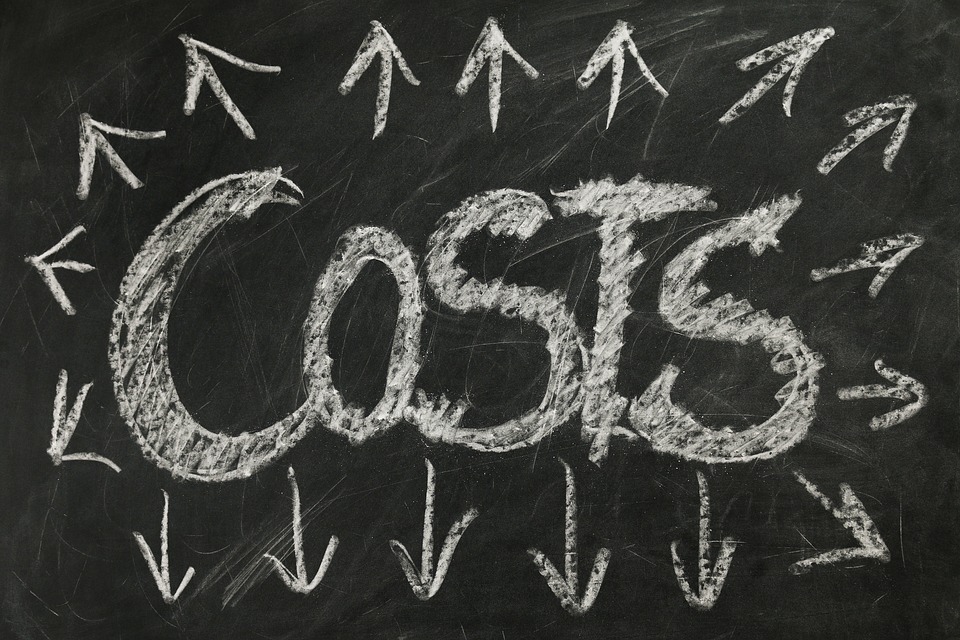 The word "costs" written on chalk with outward pointed arrows